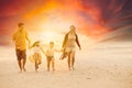 Family walking together on the beach with beautiful evening sunset golden hour sky background Royalty Free Stock Photo