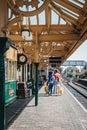 Family walking on a train platform of Sheringham train station, Norfolk, UK