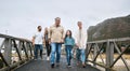 Family, walking and travel with a girl and grandparents holding hands on a pier while on holiday or vacation together Royalty Free Stock Photo