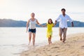 Family walking on tropical beach Royalty Free Stock Photo