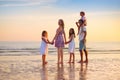 Family walking on tropical beach at sunset Royalty Free Stock Photo