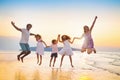 Family walking on tropical beach at sunset Royalty Free Stock Photo