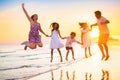 Family walking on tropical beach at sunset Royalty Free Stock Photo