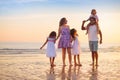 Family walking on tropical beach at sunset Royalty Free Stock Photo