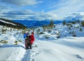 Family walking on winter mountain slope Royalty Free Stock Photo