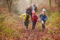 Family Walking Through Winter Woodland