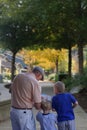 Family walks city suburb sidewalk