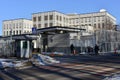 A family walks near the U.S. embassy in Kyiv. A security guard stands near the embassy