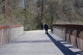 A Family walks over the Wolf River Bridge