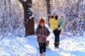 Family walks in the winter forest, mother and children, bright sunlight and shadows on the snow, beautiful nature