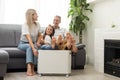 Family warm up hands over electric heater