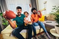 Family watching american football match on television at home Royalty Free Stock Photo