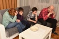 Family watching boring movie or program on TV