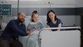 Family watching cartoon movie on television in hospital ward while waiting for medical sickness expertise Royalty Free Stock Photo