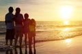 Family watching the sunset on the beach Royalty Free Stock Photo