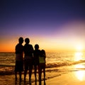 Family watching the sunset on the beach Royalty Free Stock Photo