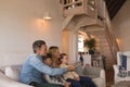 Family watching television in living room at home Royalty Free Stock Photo