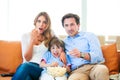 Family watching TV eating popcorn Royalty Free Stock Photo