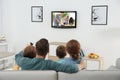 Family watching TV on sofa Royalty Free Stock Photo
