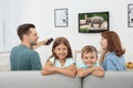 Family watching TV on sofa Royalty Free Stock Photo