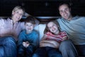 Family Watching TV On Sofa Together Royalty Free Stock Photo