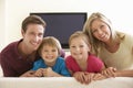 Family Watching Widescreen TV At Home Royalty Free Stock Photo