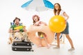 Family with water gun, flotation ring and ball