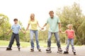 Family Wearing In Line Skates In Park