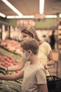 Chicago,IL- August 21, 2021:Mother and child wearing masks shopping at supermarket for editorial use only