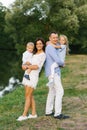 Family weekend: a beautiful young family with a small son and daughter walk outdoors Royalty Free Stock Photo