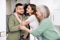 Family welcoming and embracing man who came after work trip Royalty Free Stock Photo