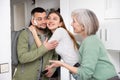 Family welcoming and embracing man who came after work trip Royalty Free Stock Photo