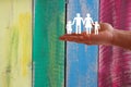 Family welfare concept with hand on wooden coloured background Royalty Free Stock Photo