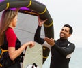 Family in wetsuits with surf boards