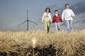 Family and wind turbines, light bulb in the ground Royalty Free Stock Photo