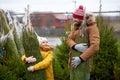 Happy family buying christmas tree at market Royalty Free Stock Photo