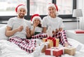 happy family eating coookies in bed on christmas