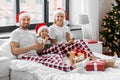 happy family eating coookies in bed on christmas