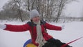 Family winter vacation. child and mother sledding in snow. Daughter and mom play in the winter park on Christmas