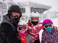 Family on winter vacations taking selfie on mountain slope