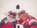 Family on winter vacations taking selfie on mountain slope