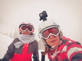 Family on winter vacations taking selfie on mountain slope