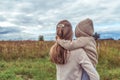 Family woman mother holds her son in her arms, little boy in sweater with hood, rest in field, parenting child care love Royalty Free Stock Photo