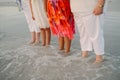 Family of Women Standing Facing the Ocean in Shallow Water Shoreline at the Beach on Vacation Outside in Nature