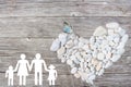 Family on wooden background with white stones heart and blue butterflies Royalty Free Stock Photo