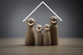 Family wooden figure smile with triangle sign on over head for protecting from help insurance and asset assurance concept