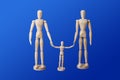 Family - wooden toy figures on blue