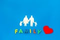 Family word and figure for adopt child concept on blue background top view
