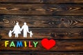 Family word and figure for adopt child concept on wooden background top view mock up