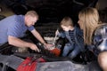 Family working on car Royalty Free Stock Photo